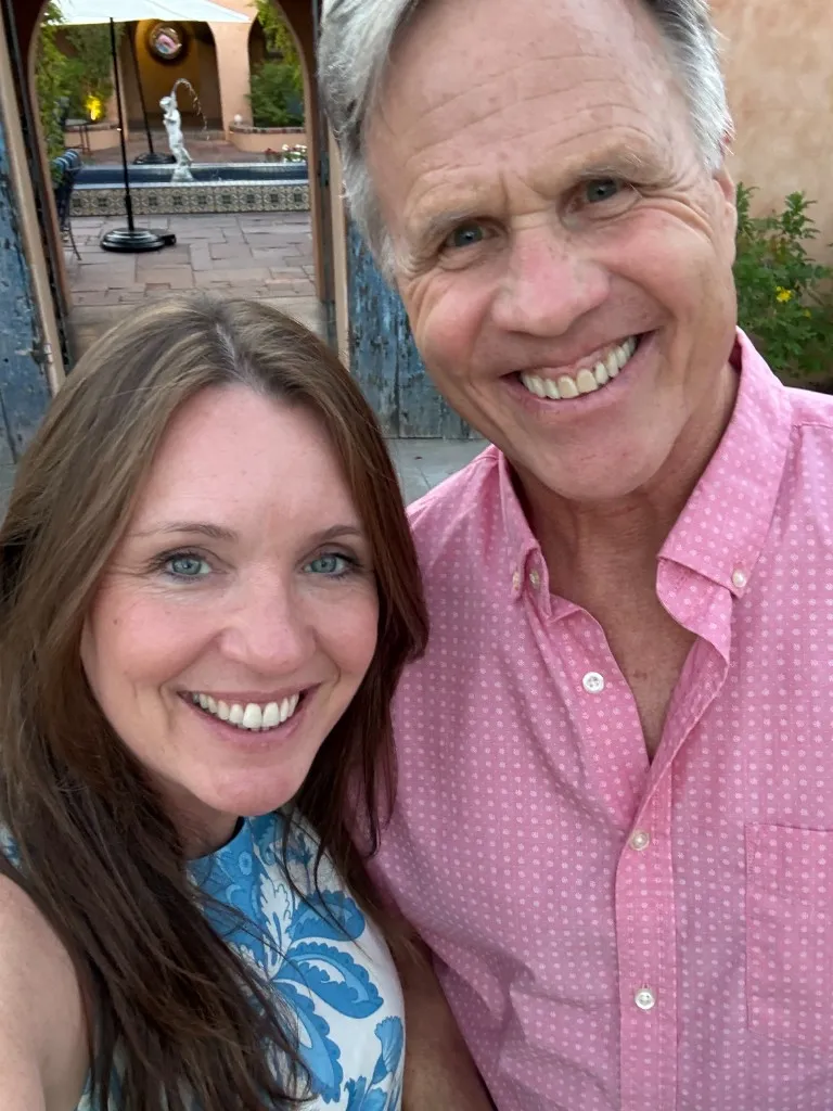 Thomas Kimball and his wife, Dana, smiling together outdoors